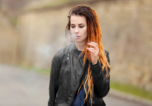 Young beautiful woman smoking weed