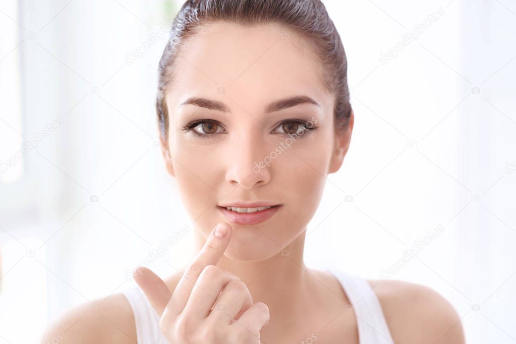 Woman applying hygienic lip balm