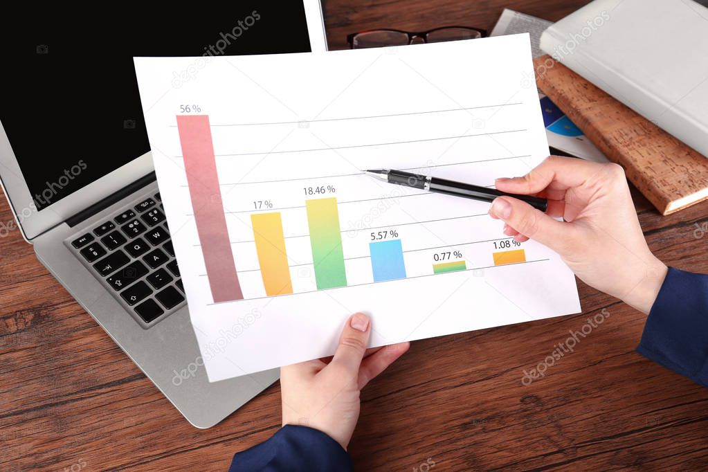 Woman holding paper sheet with diagram