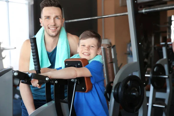 Dad and son in gym