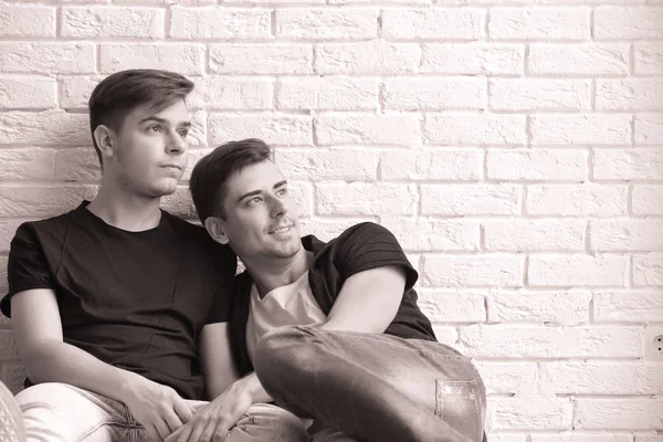 Gay couple on brick wall — Stock Photo, Image
