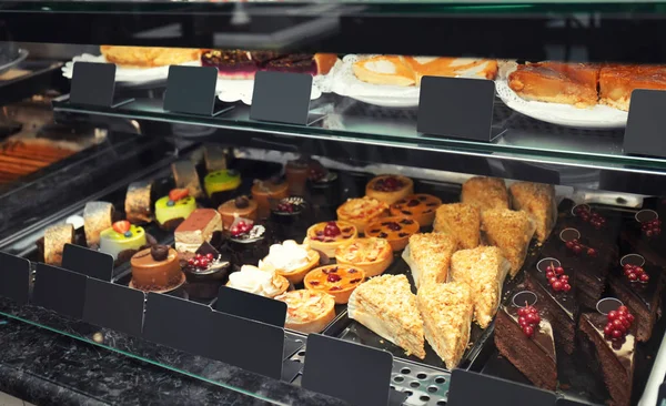 Fridge with delicious cakes