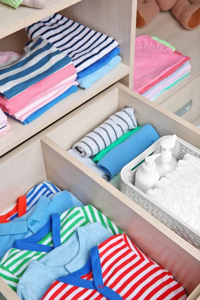 Wardrobe with crawlers and t-shirts — Stock Photo, Image