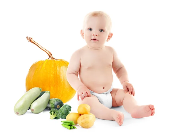 Cute baby with vegetables — Stock Photo, Image