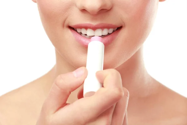 Closeup view of beautiful young woman applying lipstick, white background — Stock Photo, Image