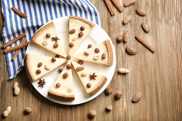 Delicious sliced cheesecake with nuts — Stock Photo, Image