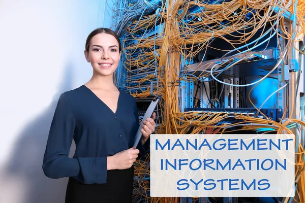 Concept of management information systems. Young engineer with clipboard in server room