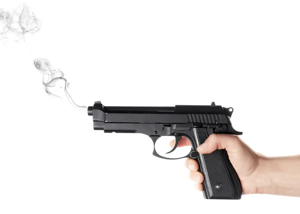 Man håller rykande pistol på vit bakgrund — Stockfoto