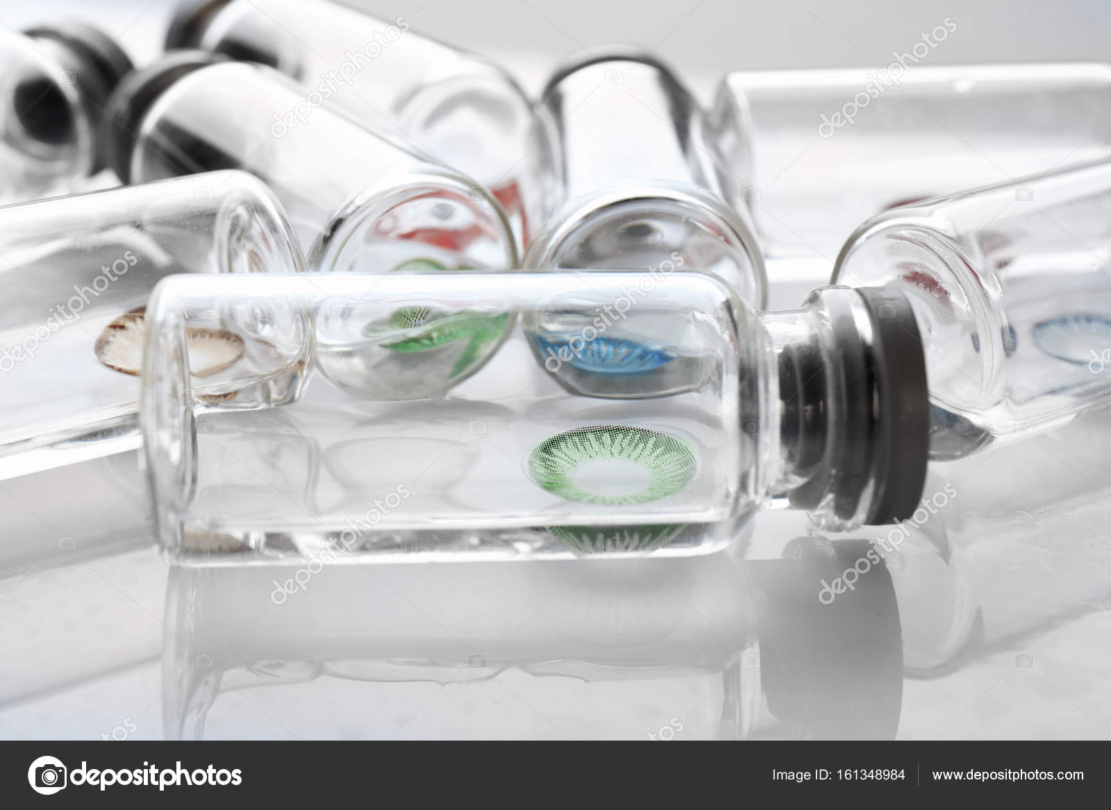 Bottles with contact lenses Stock Photo by ©belchonock 161348984