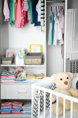 Crib and wardrobe with clothes clipart