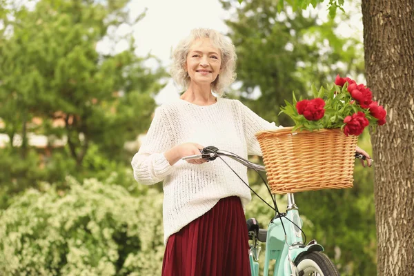 Beautiful woman with bicycle — Stock Photo, Image