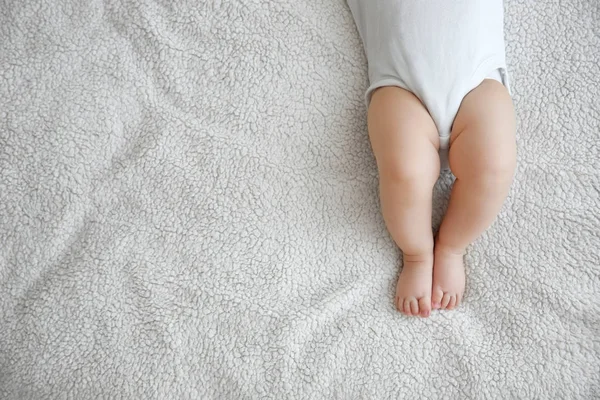 Cute little baby lying on plaid at home — Stock Photo, Image