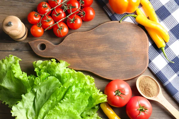 Wooden board with vegetables — Stock Photo, Image