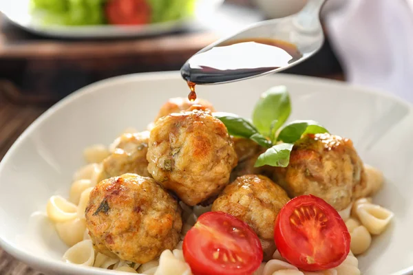 Lekkere saus te gieten in de kom met Turkije meatballs — Stockfoto