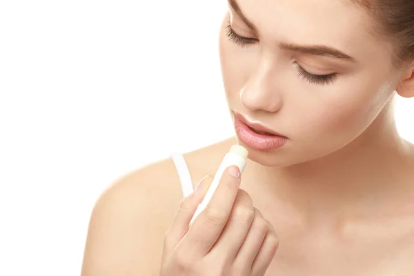 Closeup view of beautiful young woman applying lipstick, white background — Stock Photo, Image