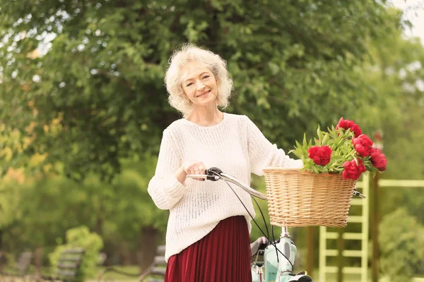 Beautiful woman with bicycle — Stock Photo, Image