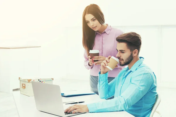 Young people using laptop for browsing internet store at workplace, Online shopping concept