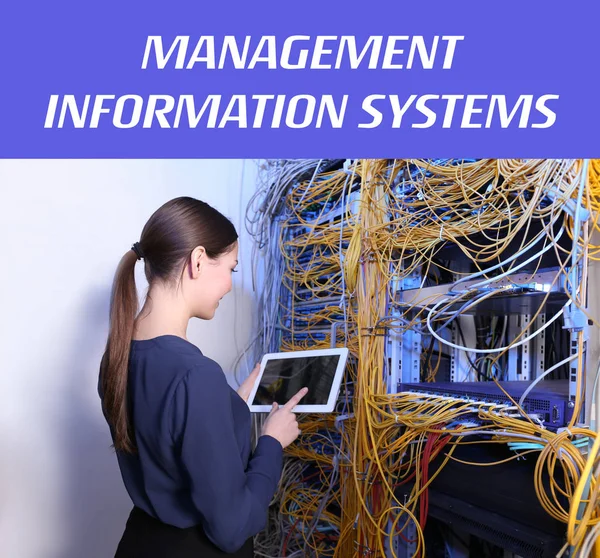 Concept of management information systems. Young engineer with tablet in server room