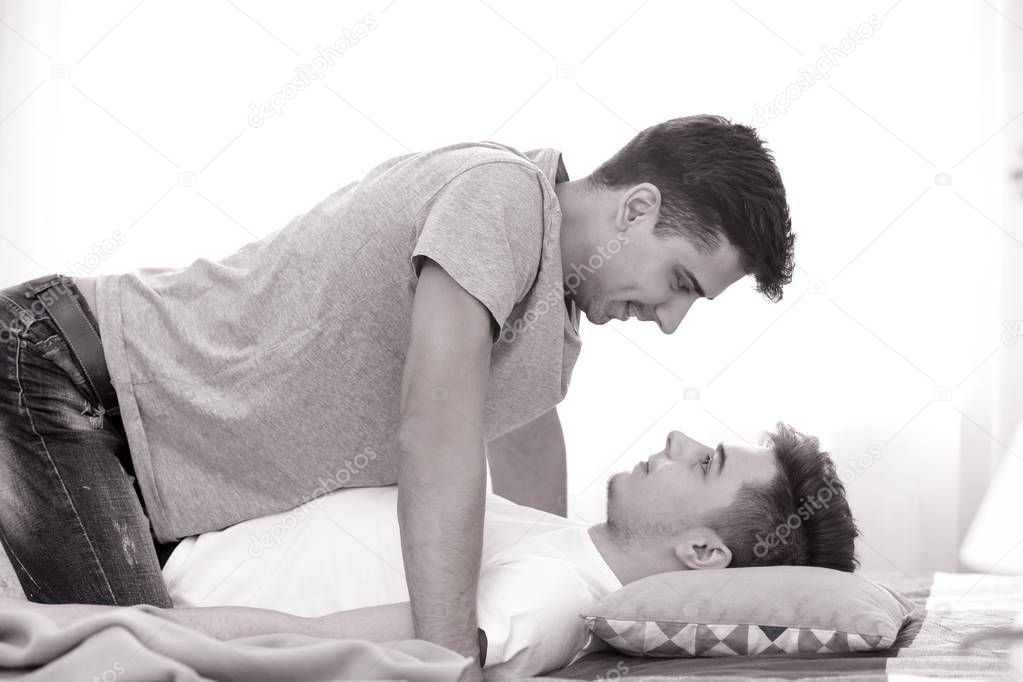 Gay couple together on bed