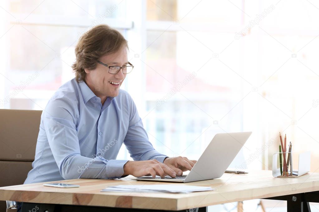 Mature man using laptop 