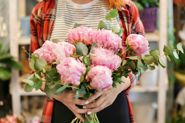 woman holding beautiful peonies