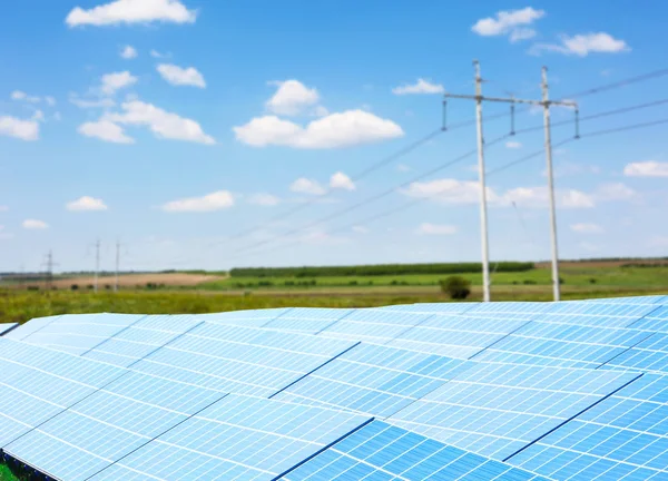 Solar panels and electrical transmission towers — Stock Photo, Image