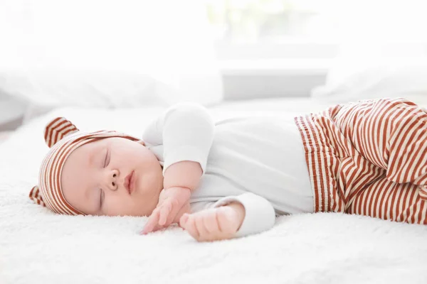 Cute little baby sleeping on plaid at home — Stock Photo, Image