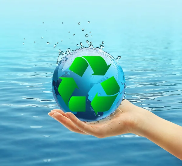 Female hand holding globe and sign of recycling — Stock Photo, Image