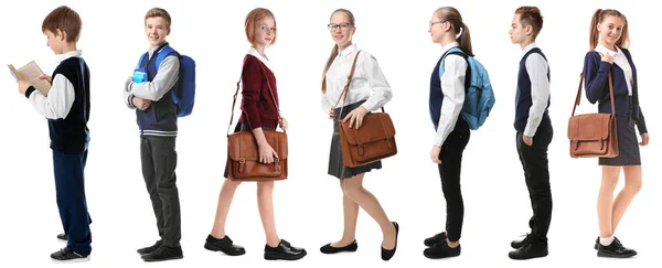 Collage van kinderen in verschillende schooluniformen op witte achtergrond — Stockfoto