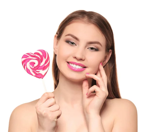 Beautiful young woman with lollipop on white background — Stock Photo, Image