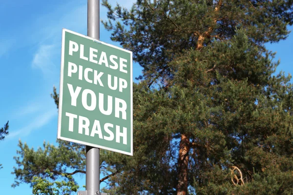 Signboard with text PLEASE PICK UP YOUR TRASH