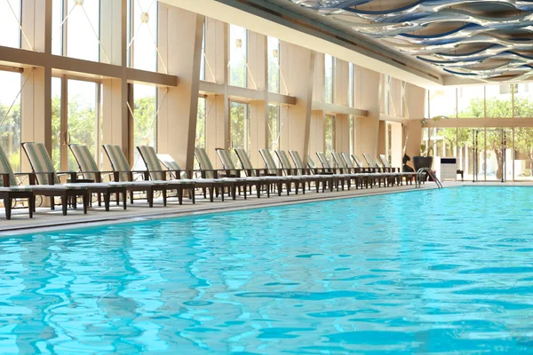 Chaise lounges near swimming pool — Stock Photo, Image