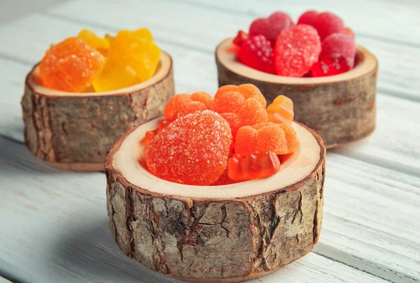 Candies in wooden cups — Stock Photo, Image