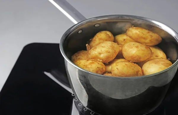 Metal pot with new potatoes — Stock Photo, Image