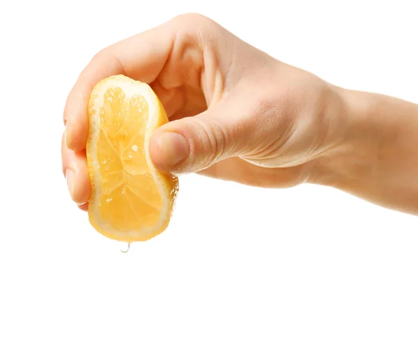 Hand squeezing half of lemon — Stock Photo, Image