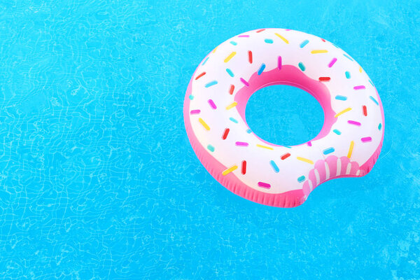 Inflatable colorful donut in pool