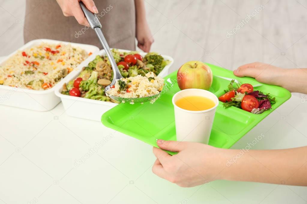 Young woman serving lunch 