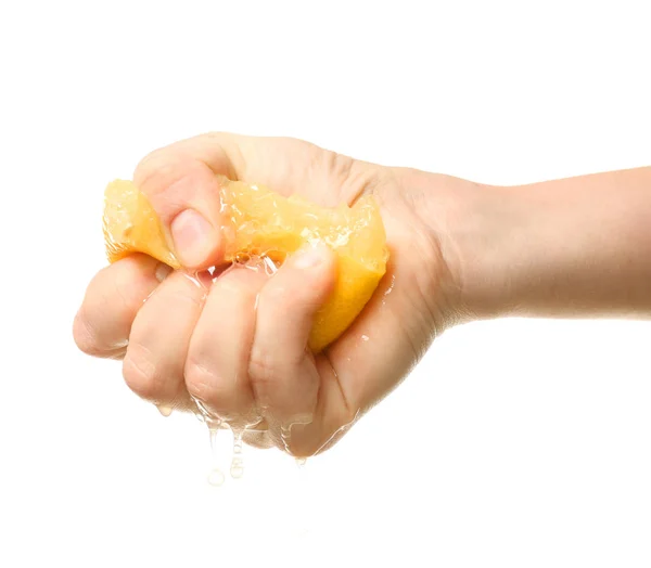 Hand squeezing half of lemon — Stock Photo, Image