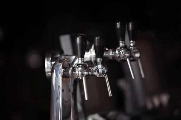 Beer taps on bar counter — Stock Photo, Image