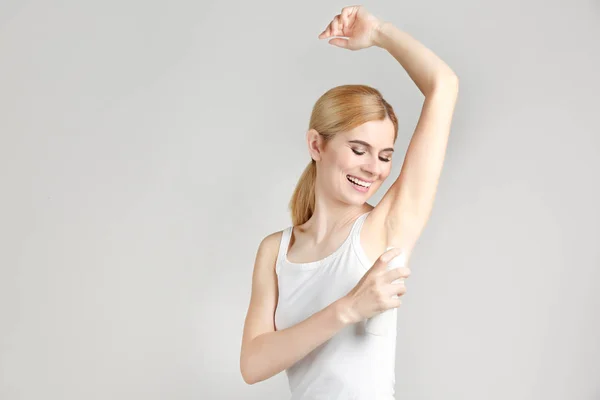 Woman using deodorant — Stock Photo, Image