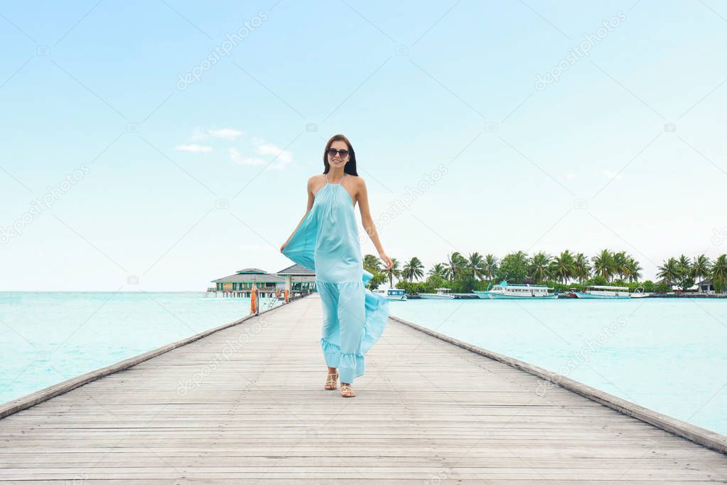 Beautiful young woman at sea resort