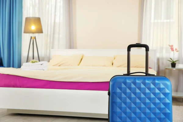 Blue suitcase in room — Stock Photo, Image