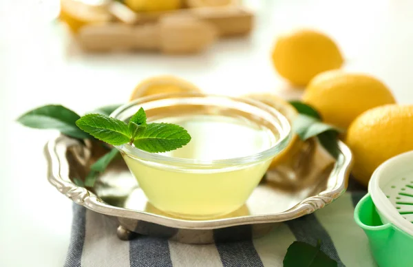 Glass bowl with lemon juice — Stock Photo, Image