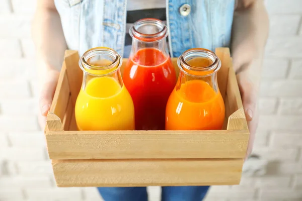 Woman with juices in bottles — Stock Photo, Image