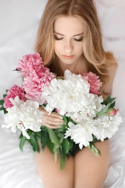 woman with bouquet of peonies