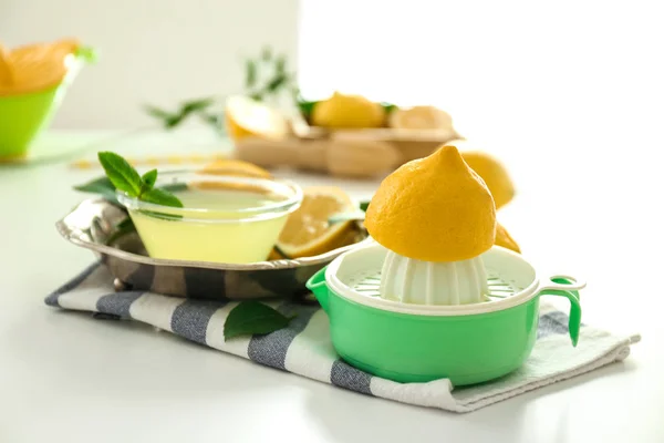 Composition with squeezer and lemons — Stock Photo, Image