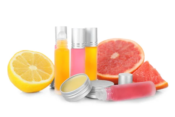 Bottles with perfume near citrus fruits — Stock Photo, Image