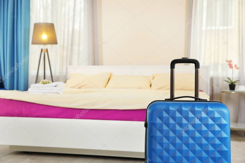 Blue suitcase in room