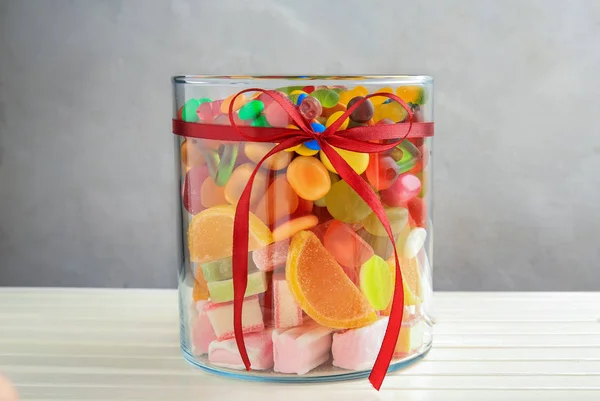 Glass jar with tasty candies — Stock Photo, Image