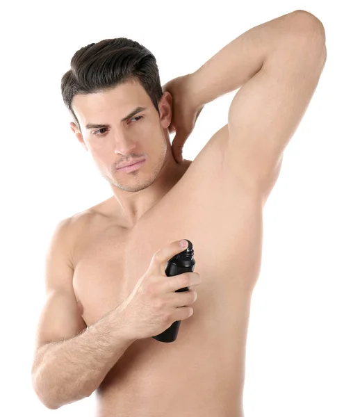 Молодой человек с дезодорантом — стоковое фото